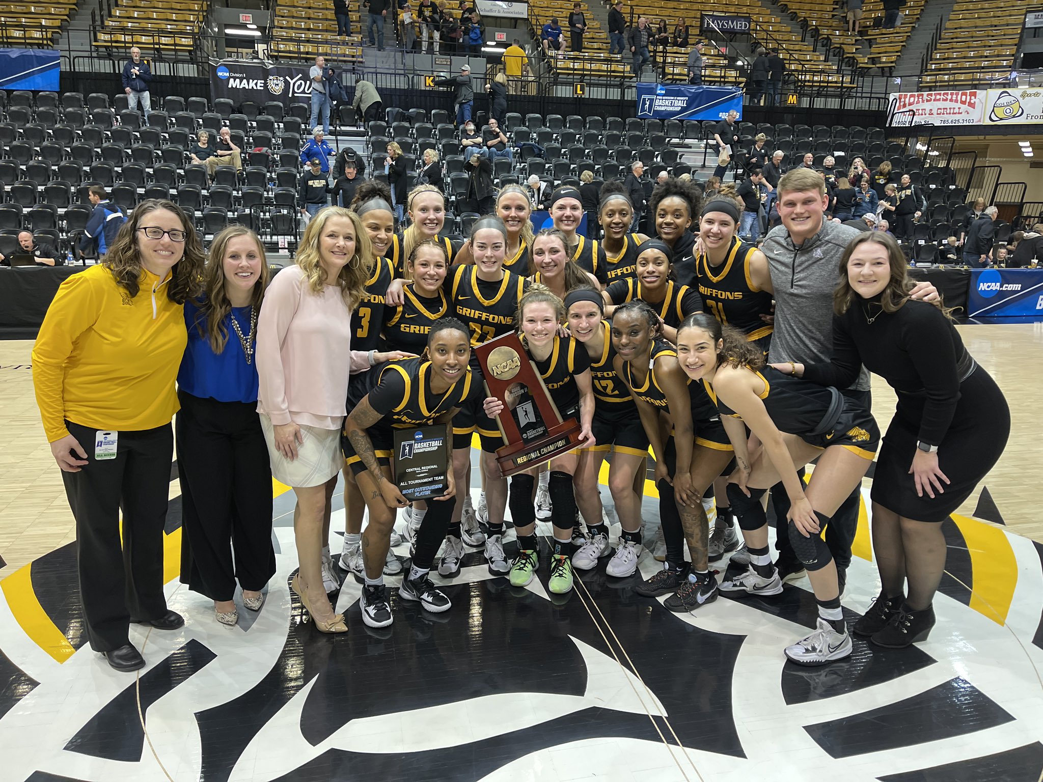 Theresa Grosbach (left, yellow) poses with the Missouri Western women's basketball team following their regional championship victory over Fort Hays State on March 14. Grosbach served as MWSU's interim A.D. for the last nine months before Andy Carter was introduced as the permanent A.D. on Monday.