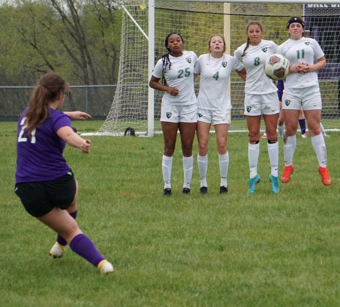 Charley Elliott (21) takes a free kick against a wall of Mid-Buchanan defenders.