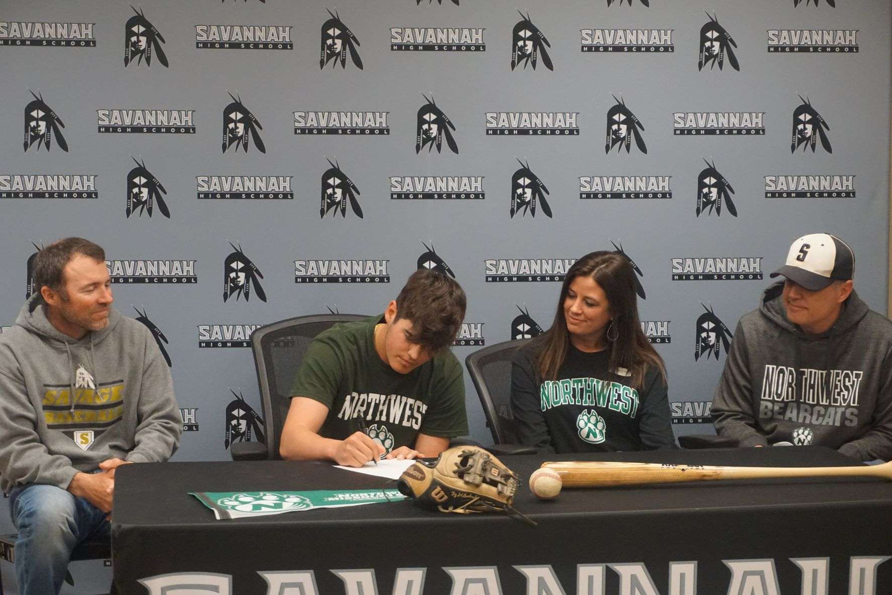 Savannah's Ty Hilsabeck (center) signs his national letter of intent for Northwest Missouri State baseball on Friday at Savannah High School. Photo by Tommy Rezac.