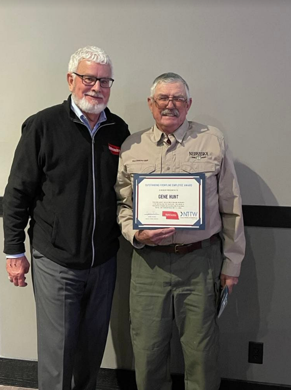 Nebraska Tourism executive director, John Ricks (left), presents the award to Gene Hunt (right).<br>