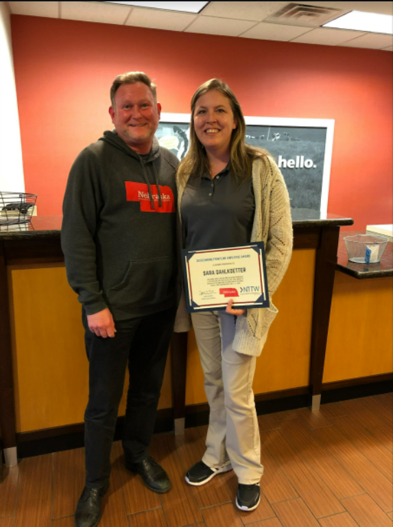 Micheal Collins (left) from Nebraska Tourism presents the award to Sara Dahlkoetter (right).<br>