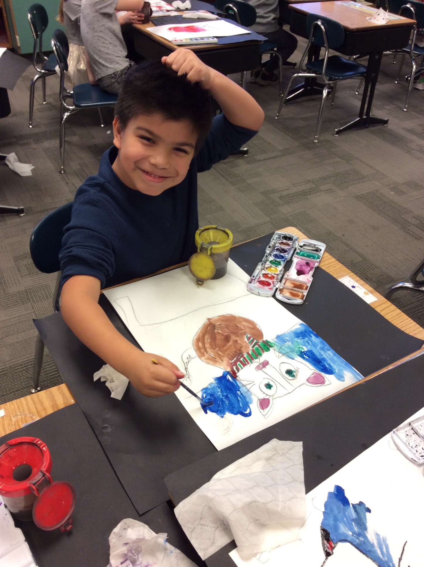 A first grader at Eisenhower Elementary School is seen here working on a watercolor piece.