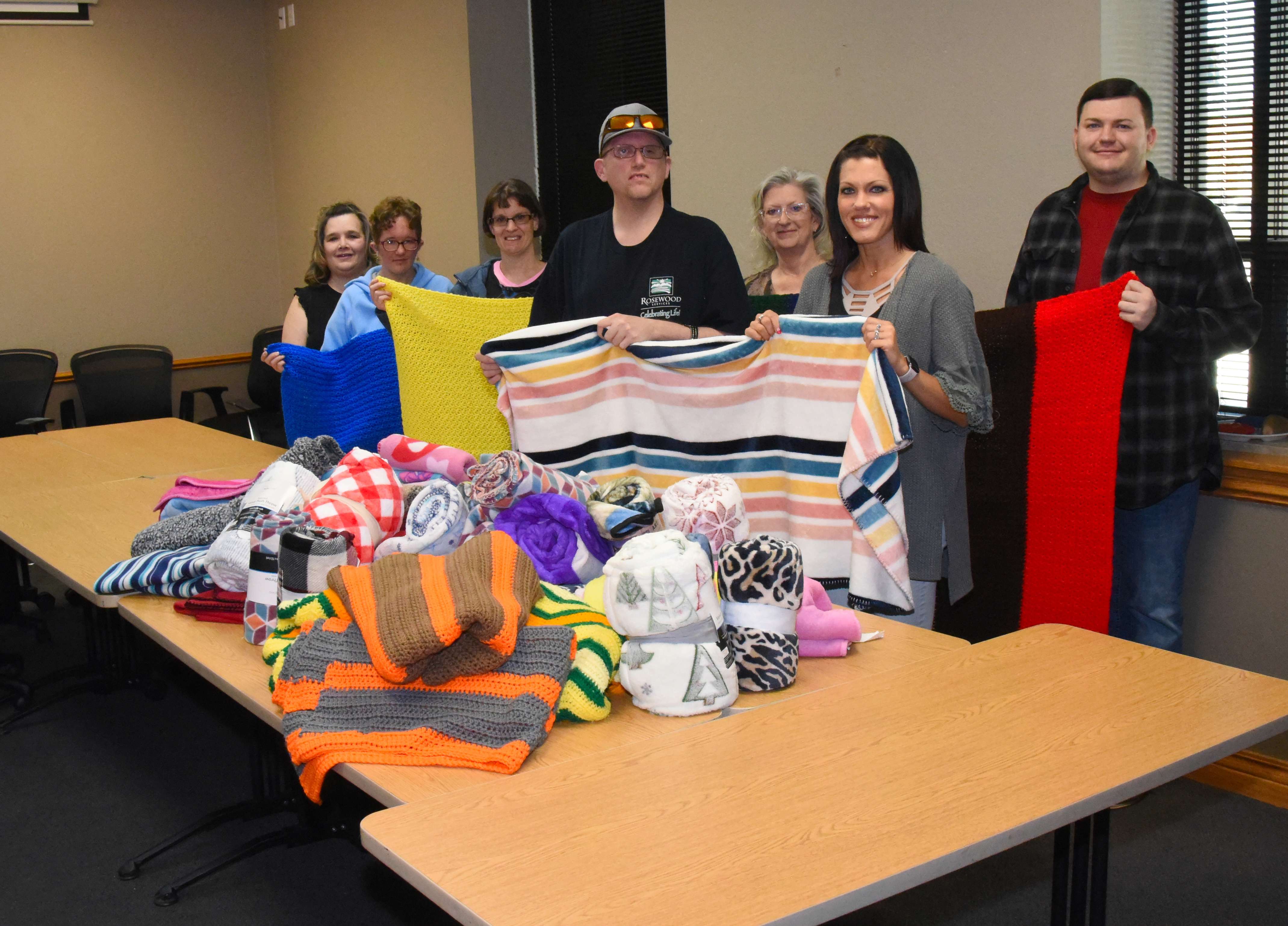 Rosewood Miracle Workers AKTION Club members are photographed along with Family Crisis Center representatives with blankets donated by the community during the AKTION Club blanket drive conducted from January through March. Pictured left to right are Frankie Pelster (AKTION Club sponsor); Abbey Stanley; Alex Randall; Jonathan Howe; Tonya Burton (AKTION Club sponsor assistant); Kylee Graves (Family Crisis Center executive director); and Tagan Brown (Family Crisis Center administrative assistant).