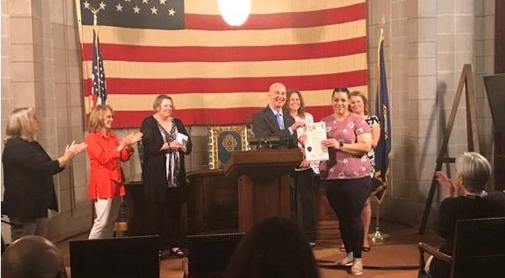 Felicia Nelsen, Executive Director of the Nebraska Foster and Adoptive Parent Association; Gov. Ricketts (presenting proclamation); CFS Director Stephanie Beasley; foster mother Janelle Jackson (accepting proclamation); and Ashley Brown, President of KVC Nebraska.