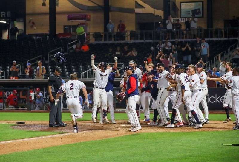 <b>Spencer Steer is greeted by jubilant teammates as he heads for home after hitting an 11th-inning walk-off home run.</b> Photo courtesy Wichita Wind Surge