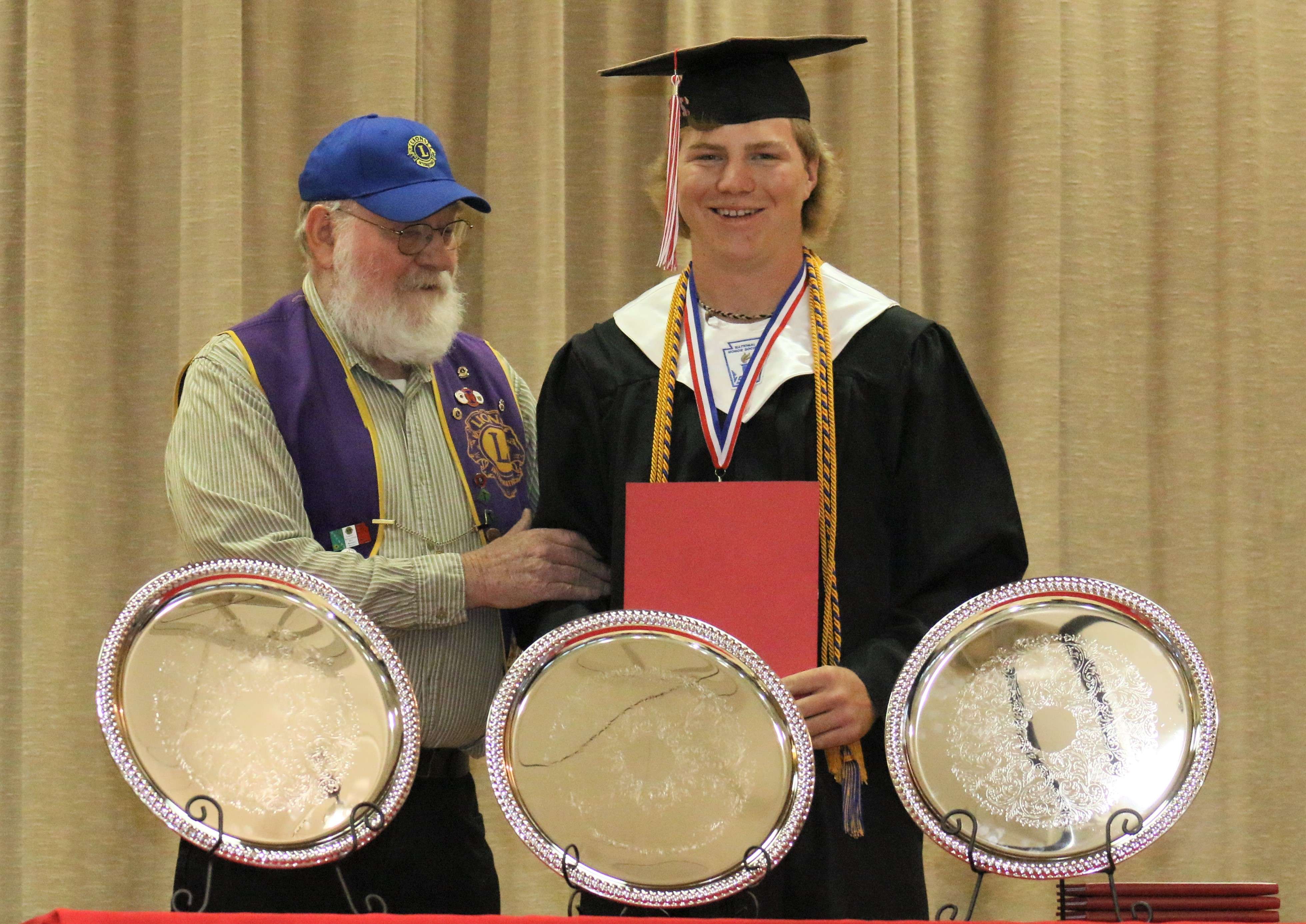Natoma Lions Club member David George presents a scholarship to Derek George. Submitted photo<br>