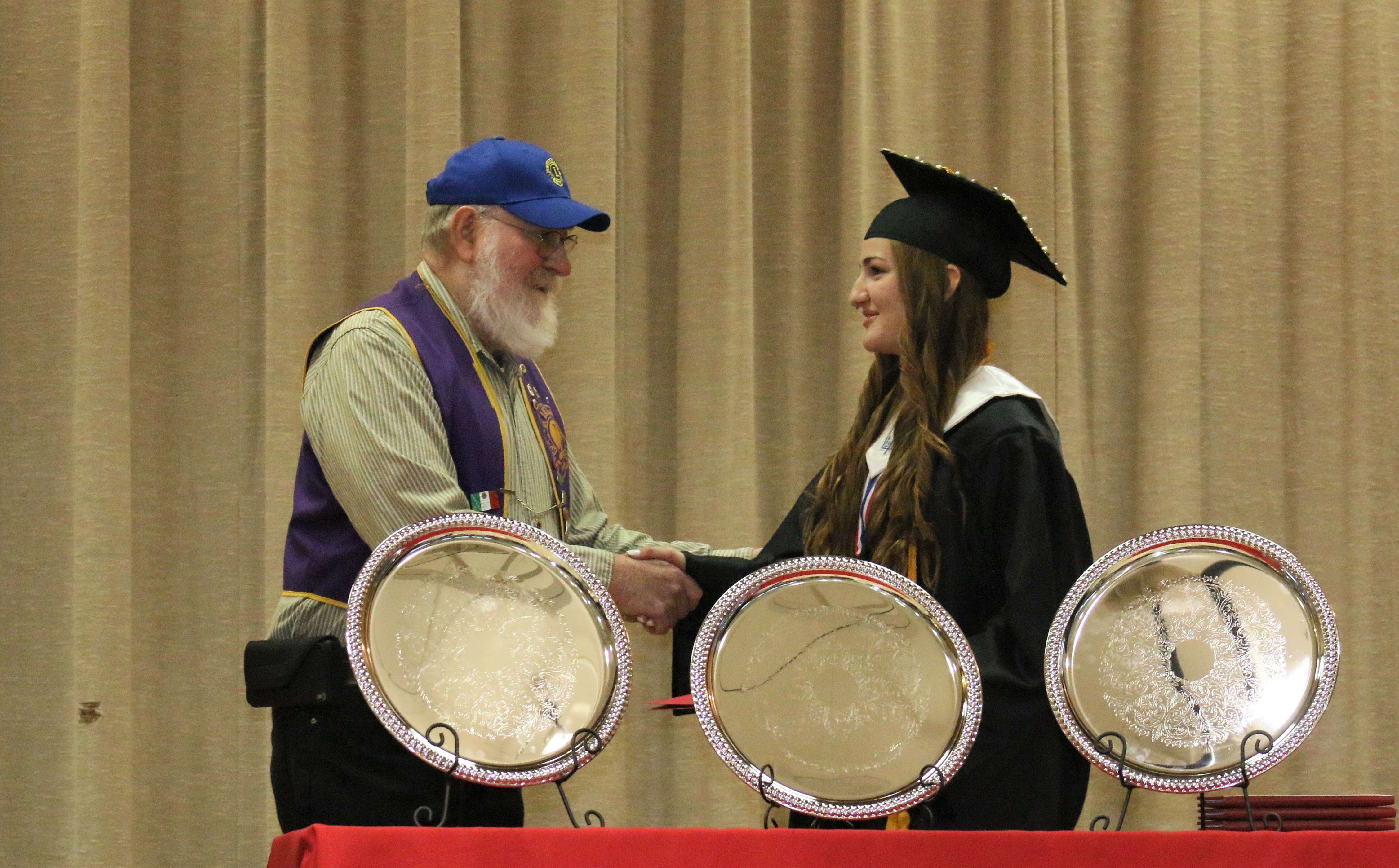 Natoma Lions Club member David George presents a scholarship to Gracyn Cotterill. Submitted photo<br>
