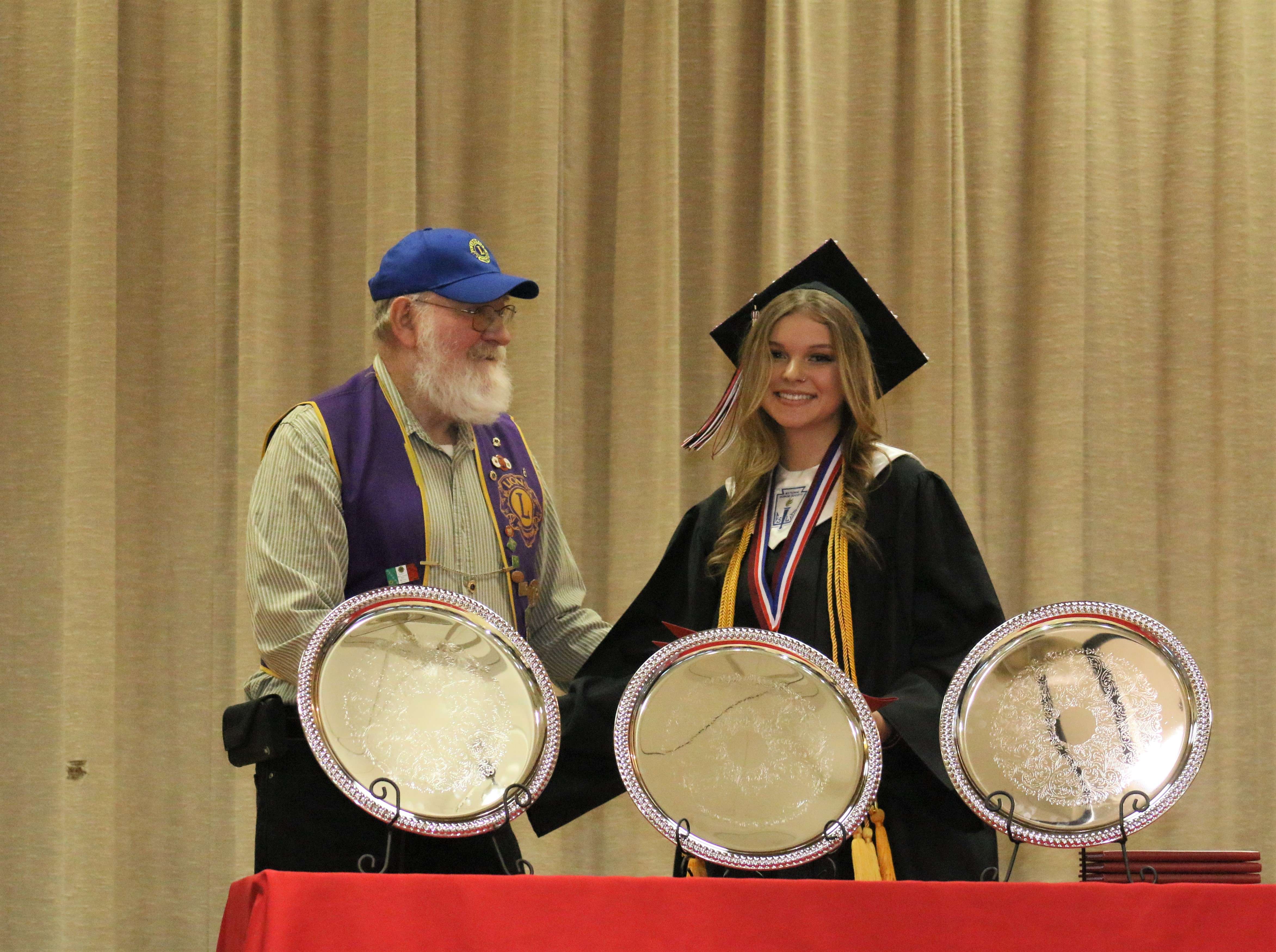 Natoma Lions Club member David George presents a scholarship to Jillian Prodrybau.