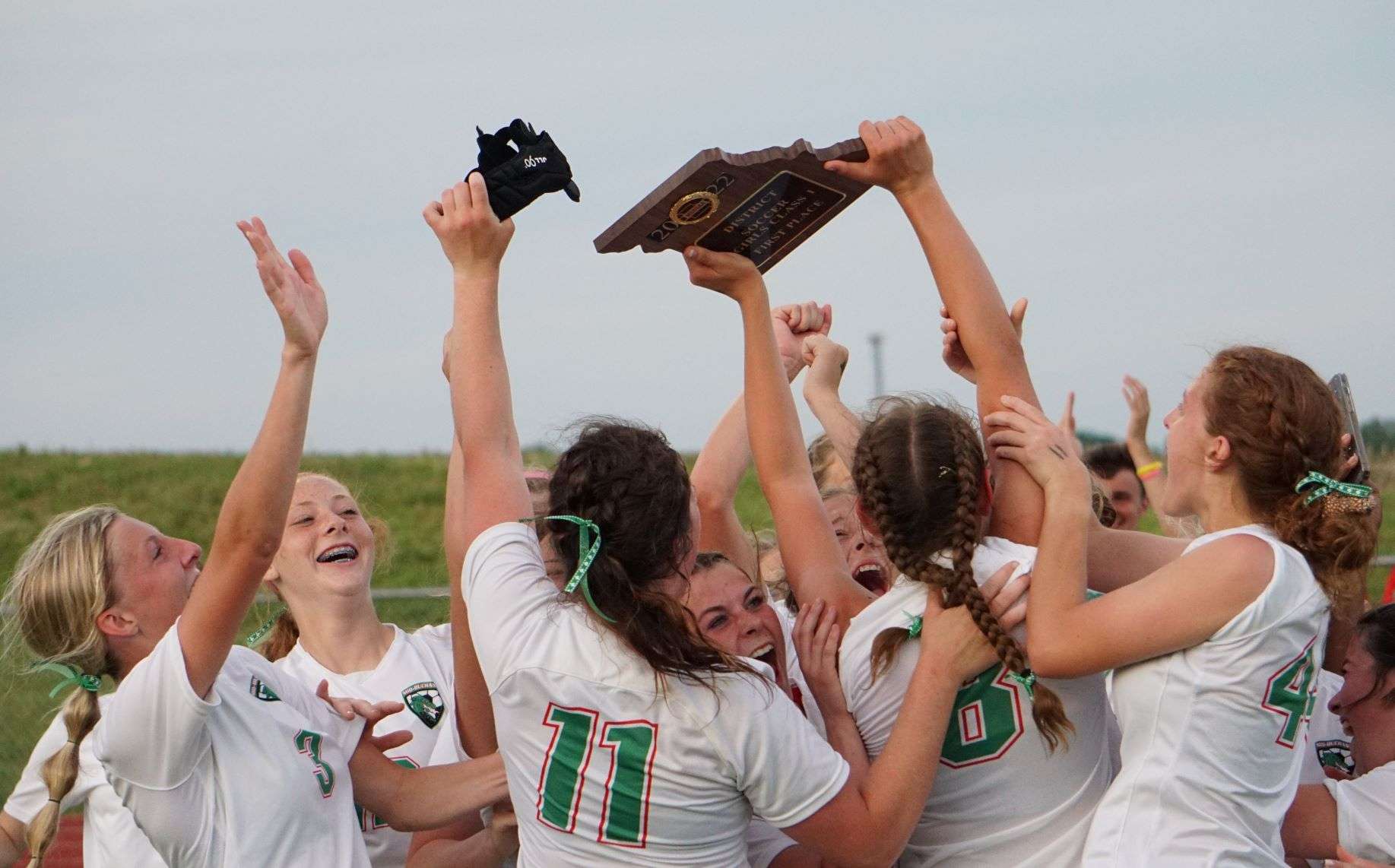 Mid-Buchanan girls' soccer celebrates and hoists the Class 1 District 8 championship plaque following their 1-0 victory over Bishop LeBlond Thursday. Photo by Tommy Rezac.