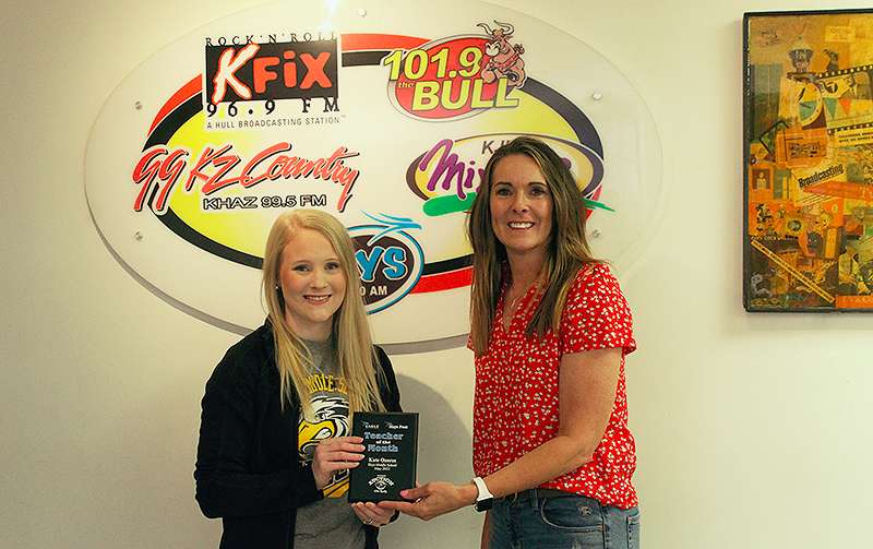 Lynette Ottley of Nations Auction Elite Realty present Kate Ozores seventh-grade science teacher at Hays Middle School, with the May Hays Post Teacher of the Month Award.