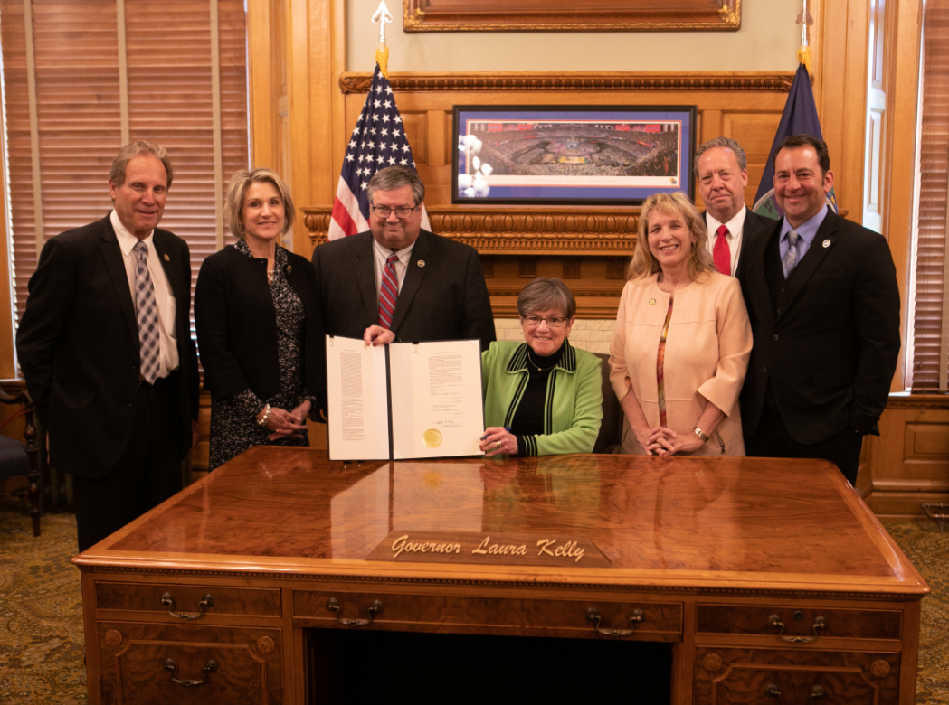 (L to R) Area legislators Sen. Rick Billinger, Goodland, Rep. Barb Wasinger, Hays, Rep. Ken Rahjes, Agra, Sen. Elaine Bowers, Concordia, and Rep. Troy Waymaster, Bunker Hill (far right) with Gov. Laura Kelly (center) after the ceremonial signing of House Bill 2239. It provides sales and property tax relief to Kansans impacted by natural disasters. The legislation was prompted by the prairie fires in Ellis, Rooks, Russell and Osborne counties Dec. 17-19, 2021. 