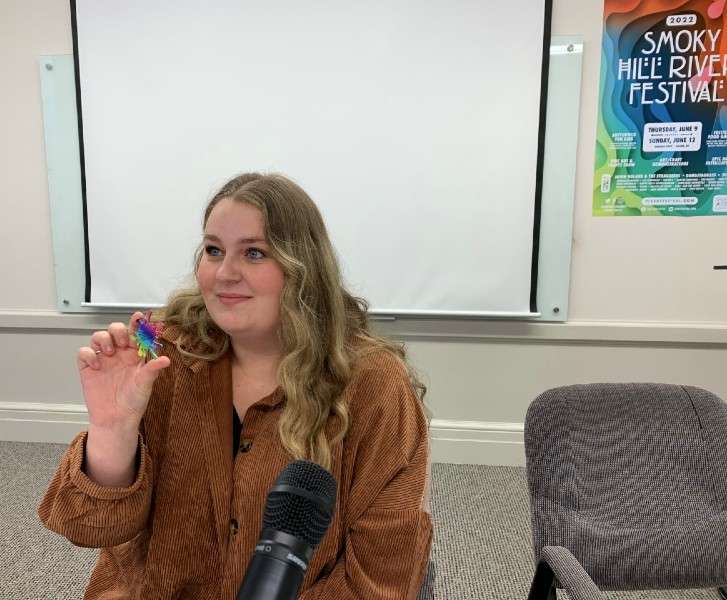 Samantha Uhler hold the festival medallion she found shortly after this morning's clue was announced. Salina Post photo.