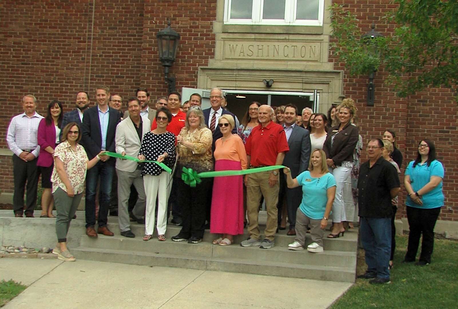 Maralene Fry, StonePost Lofts community manager, cuts the Hays Chamber ribbon at an open house May 31.