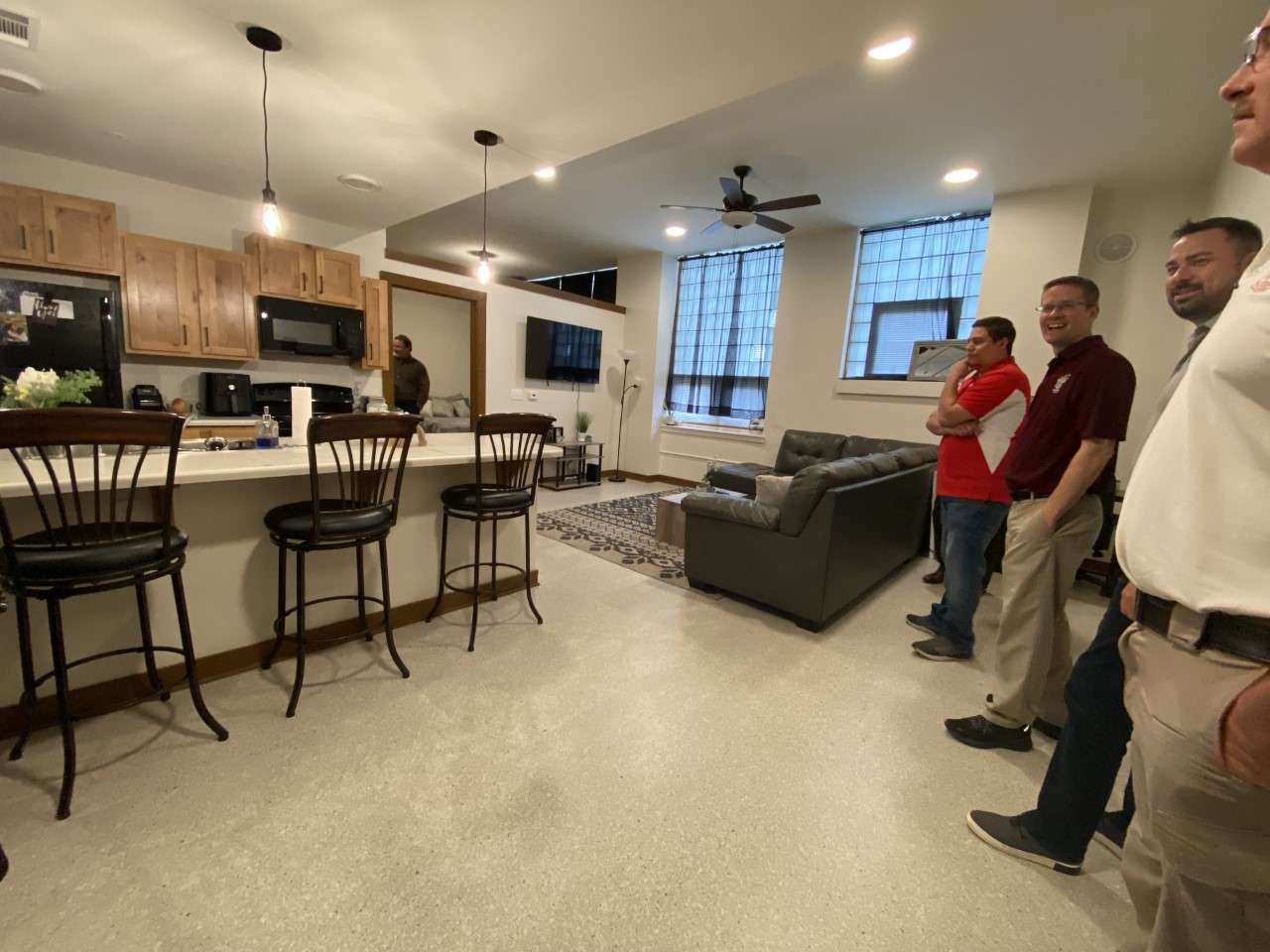 Kitchen and living area of a StonePost Loft apartment. Each apartment includes a private bathroom and washer/dryer stack.&nbsp;