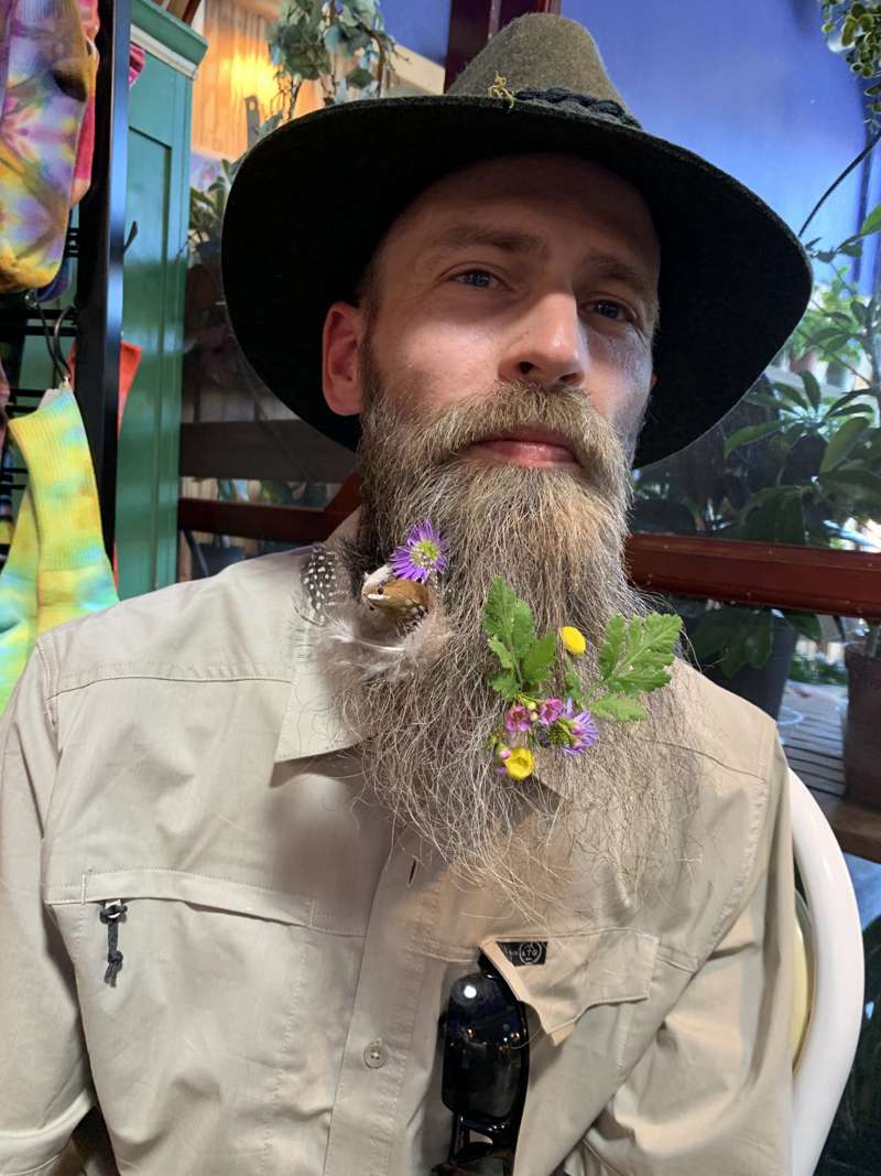 <b>Dustin sported multiple flowers, some feathers, and a little bird in his beard.</b> Salina Post photos