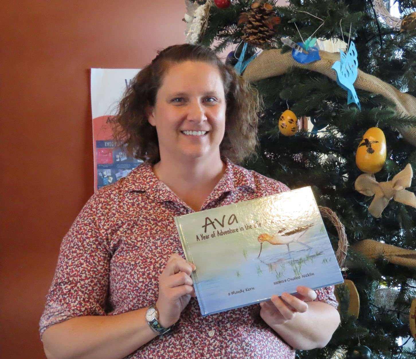 Mandy Kern poses with a copy of her children's book in a Dec. 2021 photo.