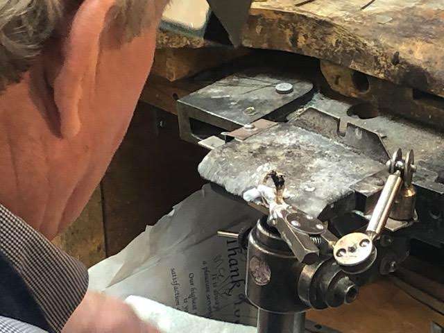 Westphal uses a delicate touch to attach prongs that will hold a stone in place on a ring. The work can also be done by a special laser machine, but Westphal mostly does the work by hand.