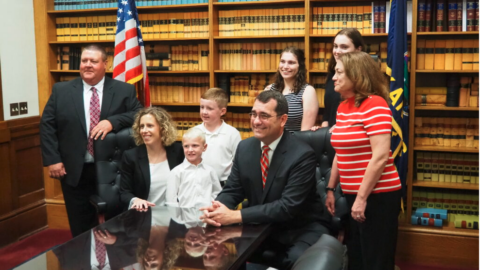 Attorney General Derek Schmidt, the Republican candidate for governor, proposed a tax reform package that would exempt retirement benefits from state income tax. Schmidt is seated along with running mate Katie Sawyer. (Tim Carpenter/Kansas Reflector)