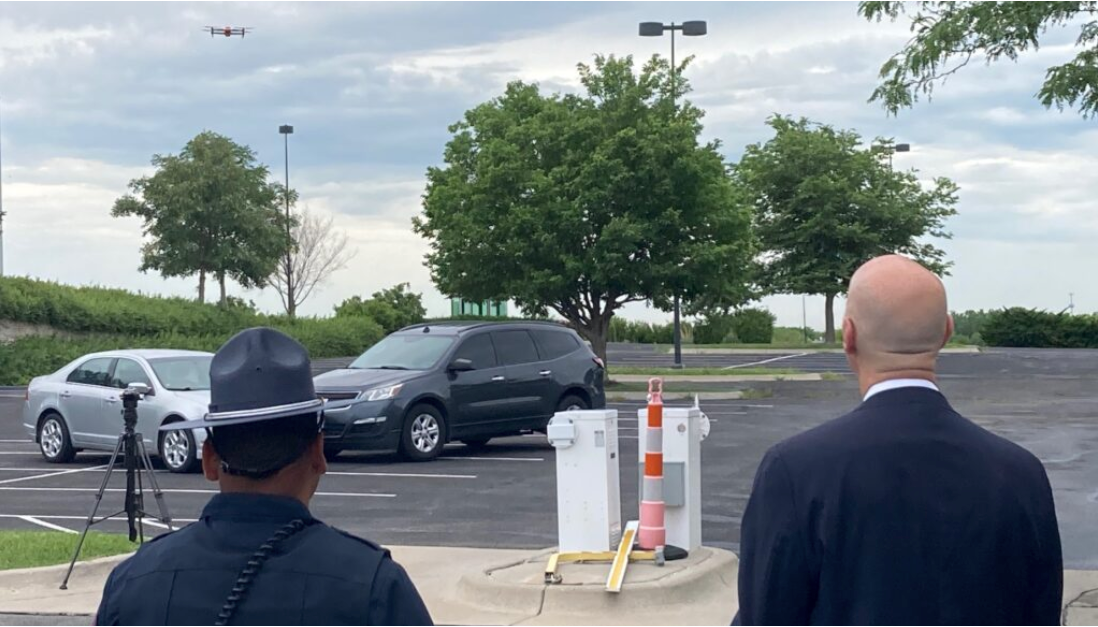 Gov. Pete Ricketts, right, takes a spin at the controls of a drone used by the Nebraska State Patrol at a press conference on July 7, 2022. (Paul Hammel/Nebraska Examiner)