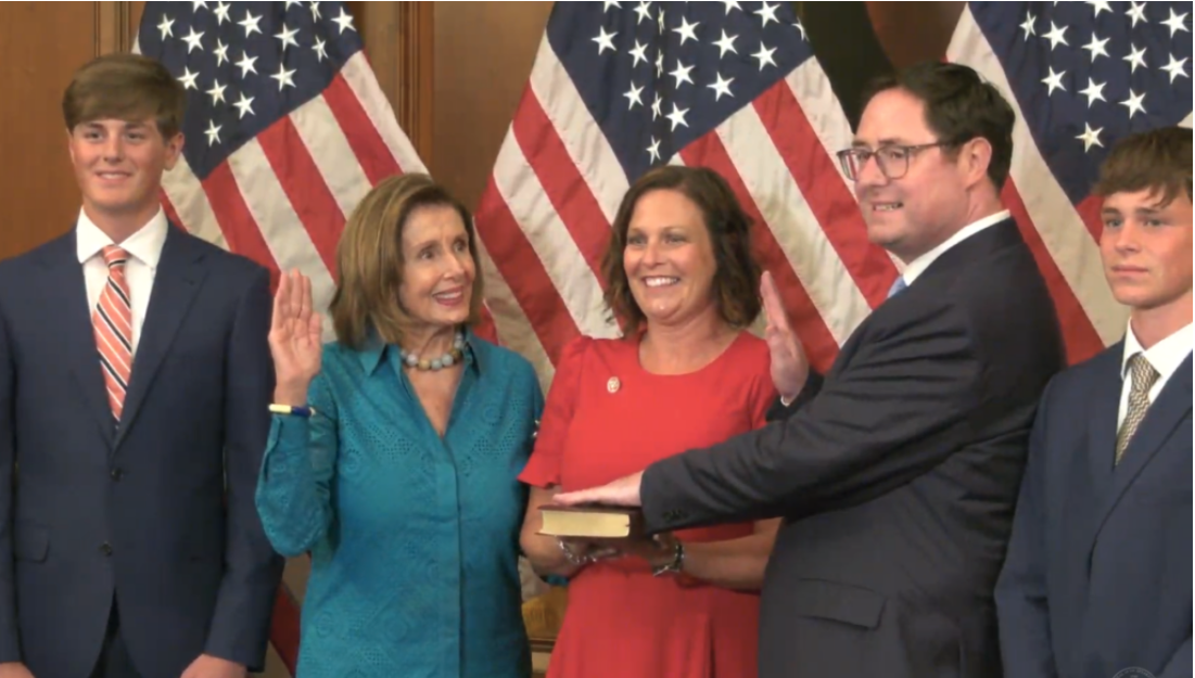 New U.S. Rep. Mike Flood, R-Neb., was sworn in Tuesday evening by Speaker of the House Nancy Pelosi to fill out the 1st Congressional District term of Jeff Fortenberry, who resigned after being convicted of lying to federal agents. Flanking Flood are his sons, Brendan and Blake, and wife, Mandy. (Screen shot of video feed from Speaker Nancy Pelosi’s office)