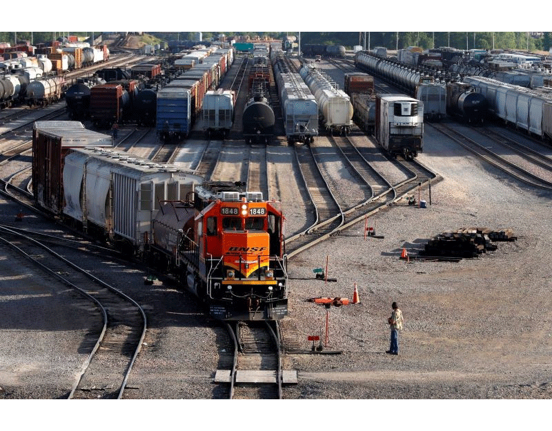 A BNSF rail terminal worker monitors the departure of a freight train, on June 15, 2021, in Galesburg, Ill. President Joe Biden is widely expected to name a board of arbitrators to intervene in a freight railroad contract dispute before a Monday, July 18, 2022, deadline, and that will prevent 115,000 workers from going on strike for at least 60 days. (AP Photo/Shafkat Anowar, File)