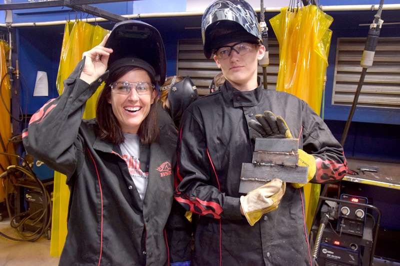 <b>Michelle Peck, executive director of The Garage, poses with museum staffer Brady Hemmer and his first welds.</b>