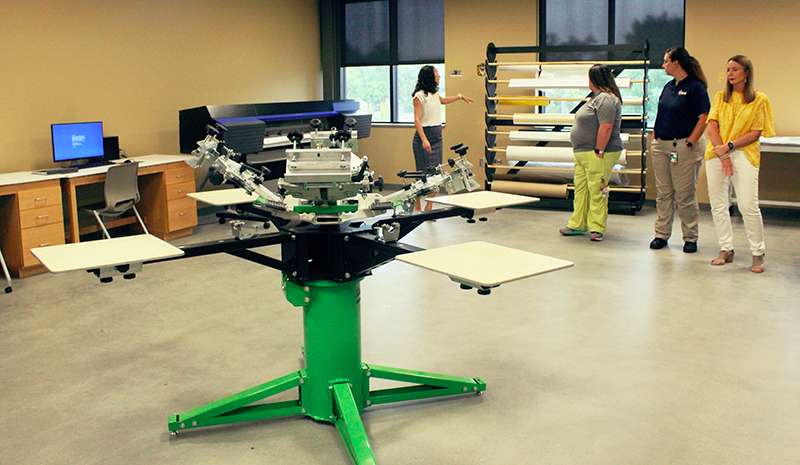 The graphic design lab in the Center for Applied Technology includes a screen printer and a vinyl printer. Students learn how to create logos, print T-shirts and edit videos. Photo by Cristina Janney/Hays Post<br>