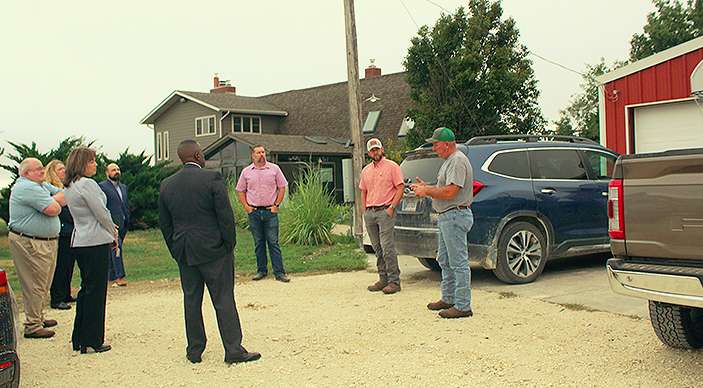 Representatives of the U.S. Department of Health and Human Services, Substance Use and Mental Health Services Administration and High Plains Mental Health Center talk with farmers on a farm southwest of Hays, which is owned by Dylan Bryant, center. Photo by Cristina Janney/Hays Post