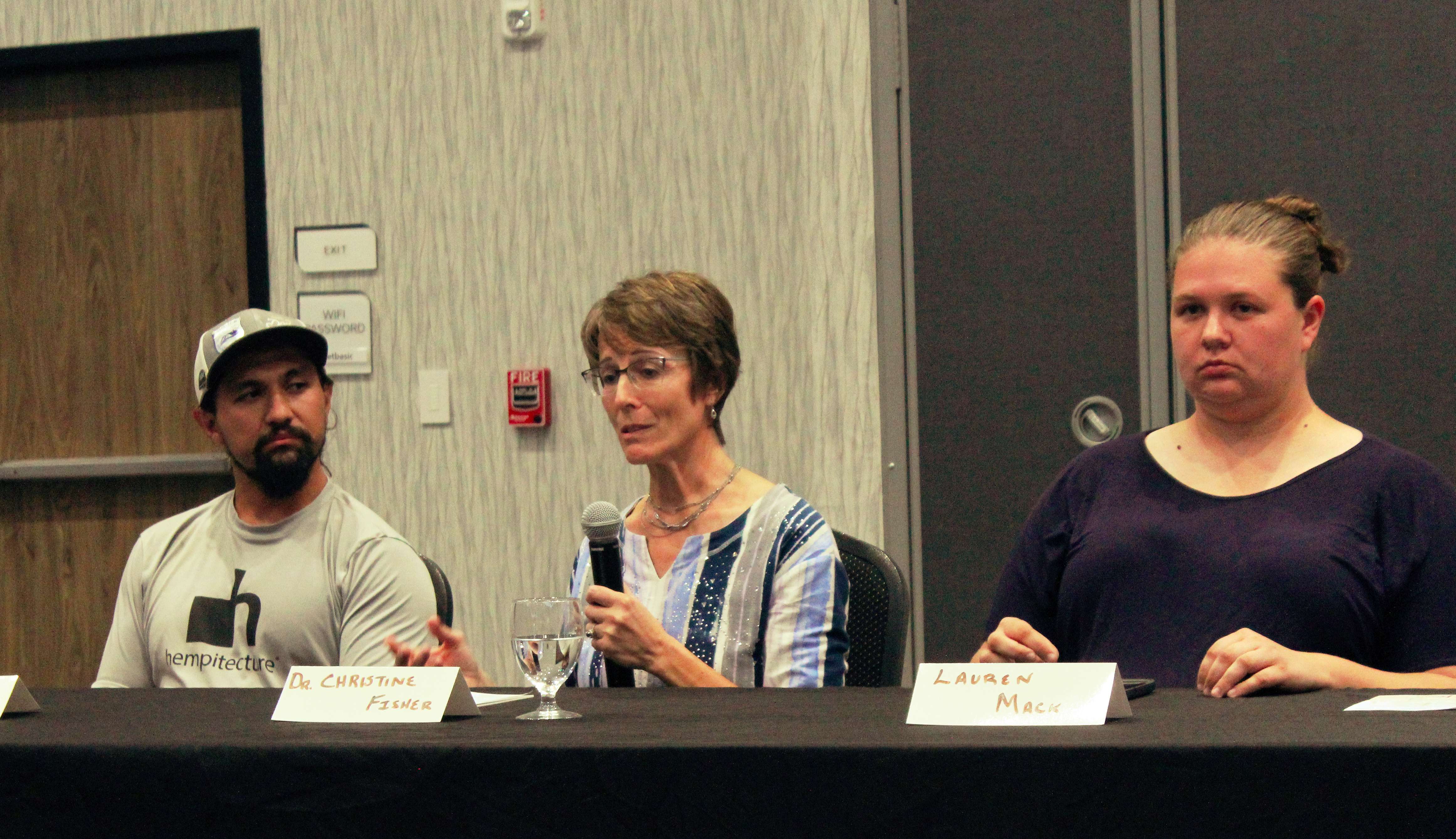 Dr. Christine Fisher, medical director of First Care Clinic, urges the expansion of integrated health care to include mental health care. She along with Angel Romero Jr, hemp farmer, left, and veterinarian Lauren Mack, right, sat on a panel on ag and mental health on Thursday in Hays. Photo by Cristina Janney/Hays Post<br>