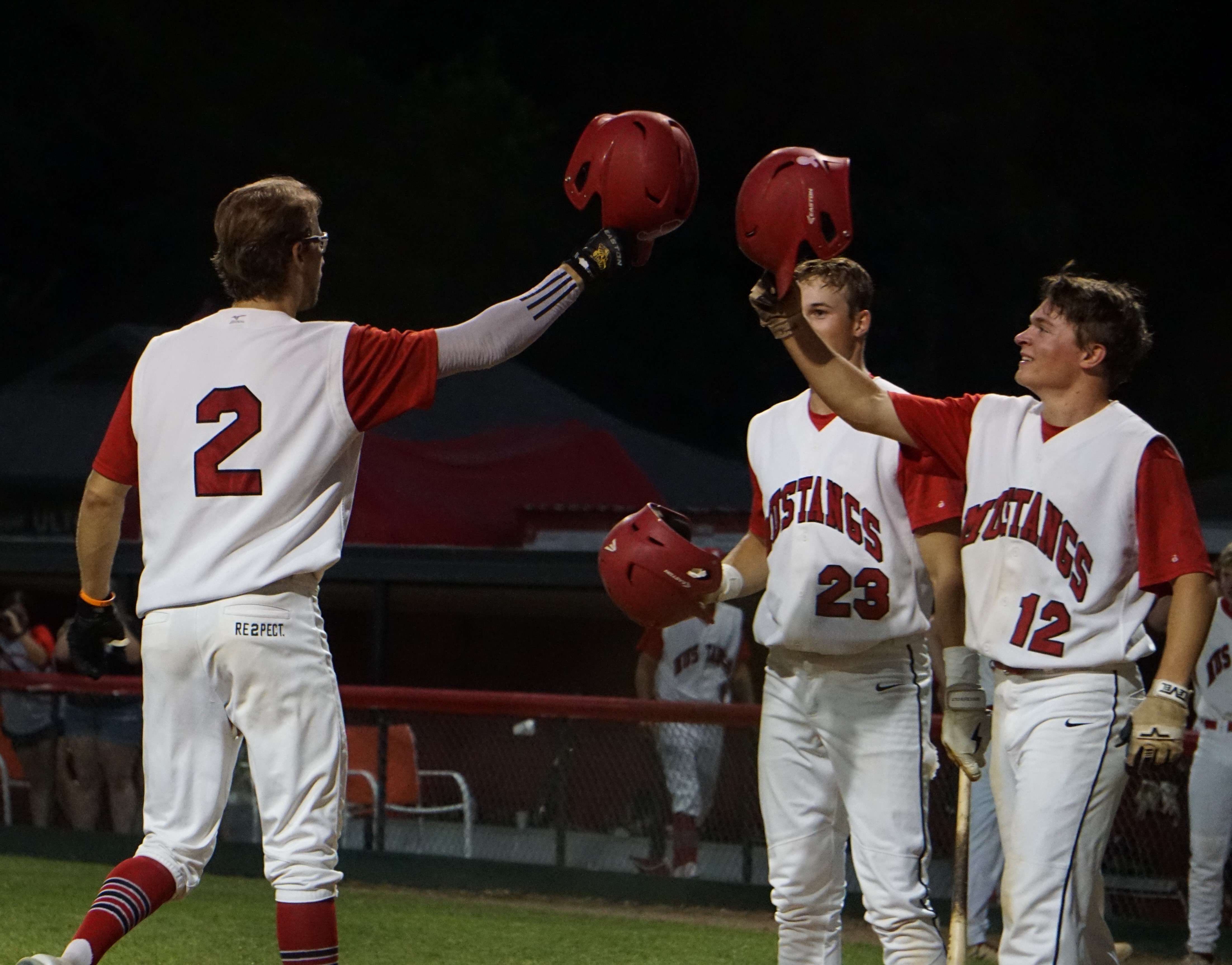 Brady Holden (2) and Noah Bodenhausen (12) celebrate a run scored.