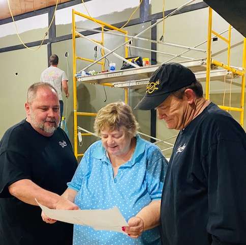 Dennis Crouse, left, Sheryl Cheely and Rick Riggs review design plans during construction of the new downtown restaurant, Tellers 1872. Crouse is the restaurant owner and Riggs is general manager. Cheely represents MyTown.