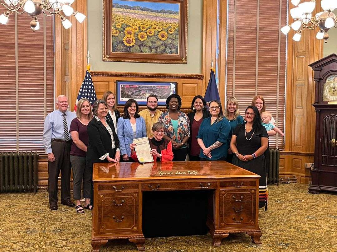 David Thomason, Ashley Goss, Brenda Bandy, Senator Dinah Sykes, Melissa Rooker, Logan Stenseng, Governor Laura Kelly, Earlisha Killen, Sapphire Garcia-Lies, Jennie Toland, Mandy Chapin, Stephanne Rupnicki, and Senator Kristen O’Shea]