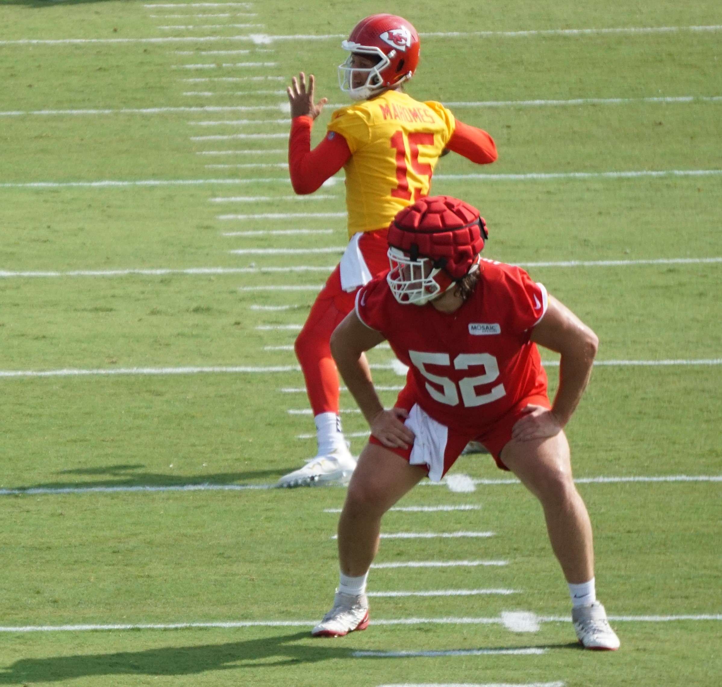 Patrick Mahomes (15) and Creed Humphrey (52). Stock photo.