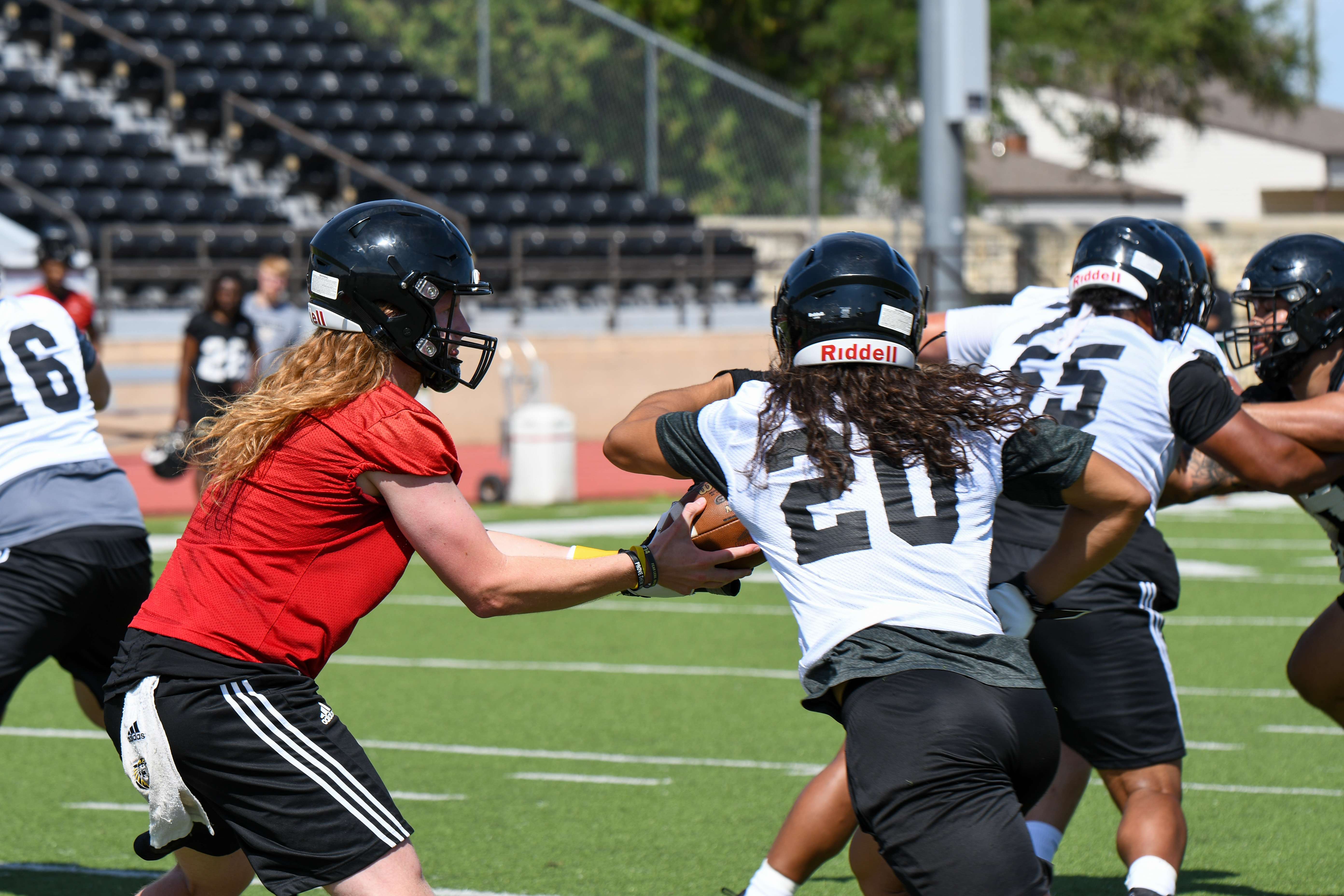 Chance Fuller hands the ball off to Adrian Soto in FHSU's first practice Monday morning at Lewis Field (Courtesy FHSU Athletics, Ryan Prickett)