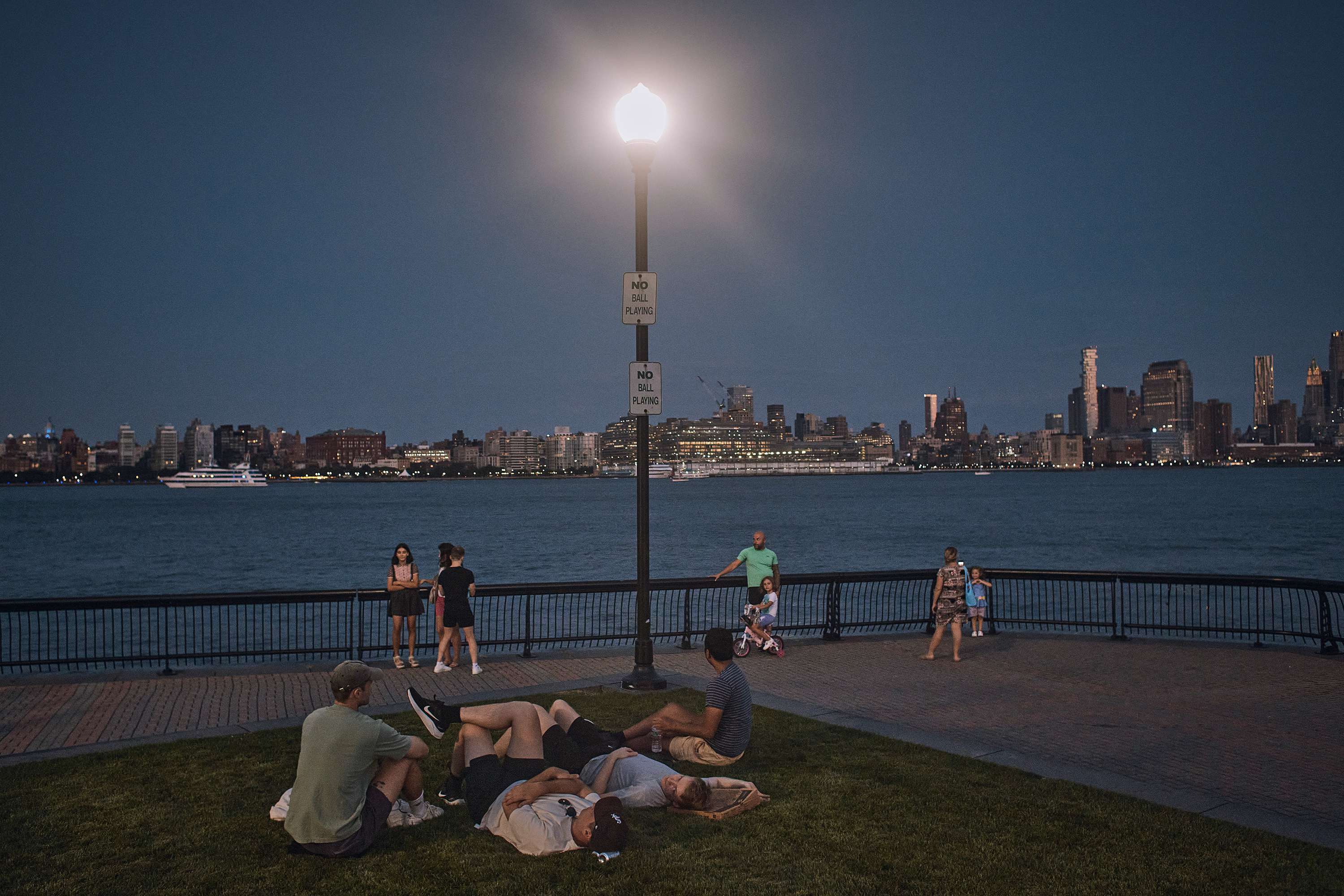 People spend time at the park at dusk during a summer heat wave, July 21, 2022, in Hoboken, N.J. The continental United States in July set a record for overnight warmth, providing little relief from the day’s sizzling heat for people, animals, plants and the electric grid, meteorologists said. (AP Photo/Andres Kudacki, File)