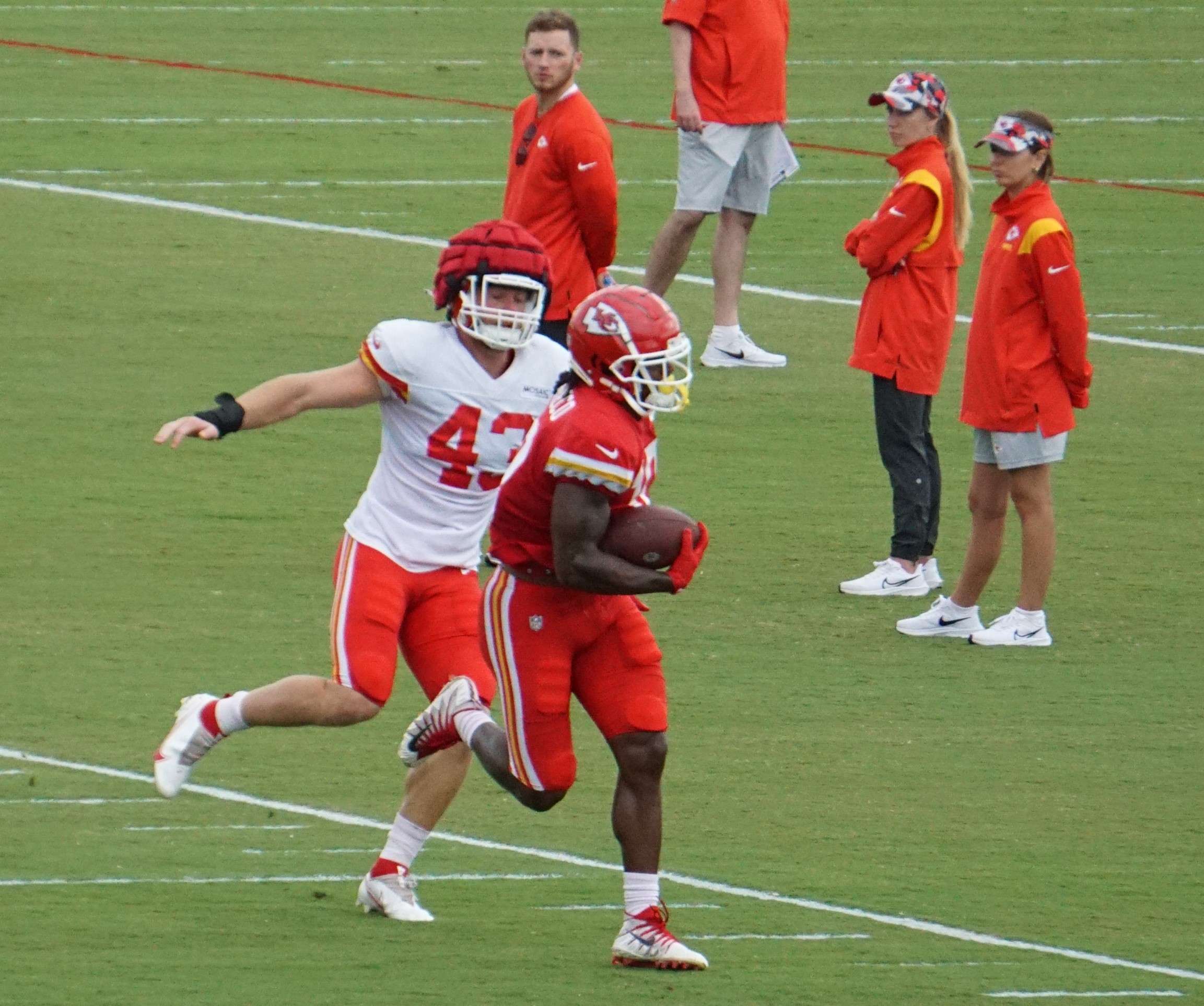 <b>Isiah Pacheco (red) runs from Jack Cochrane (43) during practice Monday.</b>