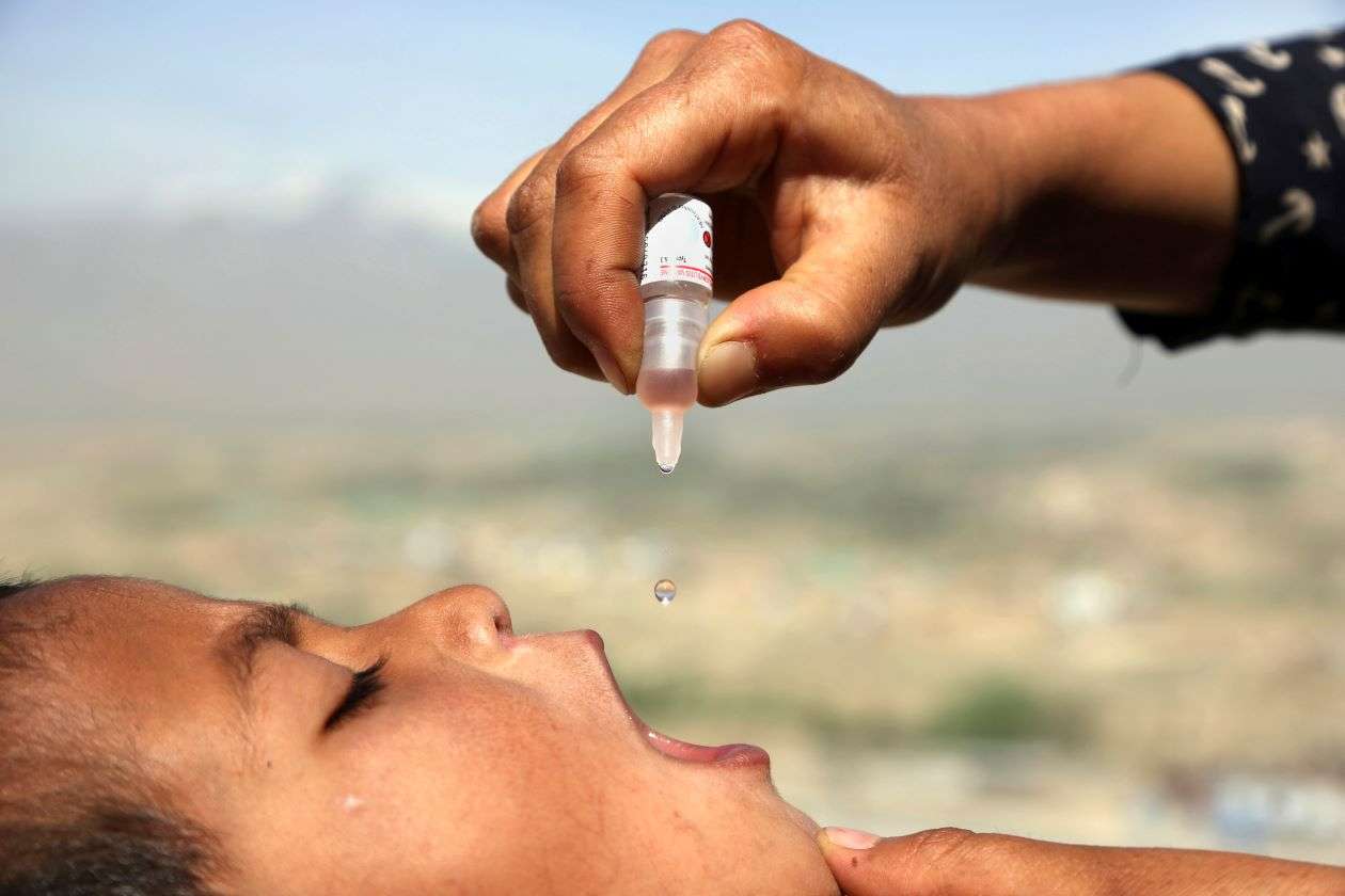 An Afghan health worker uses an oral polio vaccine on a child as part of a campaign to eliminate polio, on the outskirts of Kabul, Afghanistan, April 18, 2017. For years, global health officials have used billions of drops of an oral vaccine in a remarkably effective campaign aimed at wiping out polio in its last remaining strongholds — typically, poor, politically unstable corners of the world. Now, in a surprising twist in the decades-long effort to eradicate the virus, authorities in Jerusalem, New York and London have discovered evidence that polio is spreading there. The source of the virus? The oral vaccine itself. (AP Photo/Rahmat Gul, File)