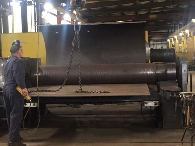 Building the main part of the boiler starts with the vessel. Here, a 5,000 pound piece of steel is rolled into a round cylinder that will become the main body of the boiler. The process takes just a few minutes.