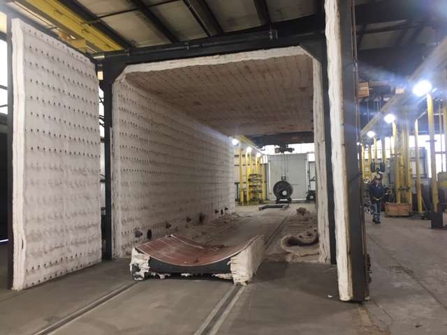 Boilers that are welded by hand must go through a heating process to strengthen all of the welds. Here, an oven prepares to take in a boiler where it will be heated to 1,100 degrees.