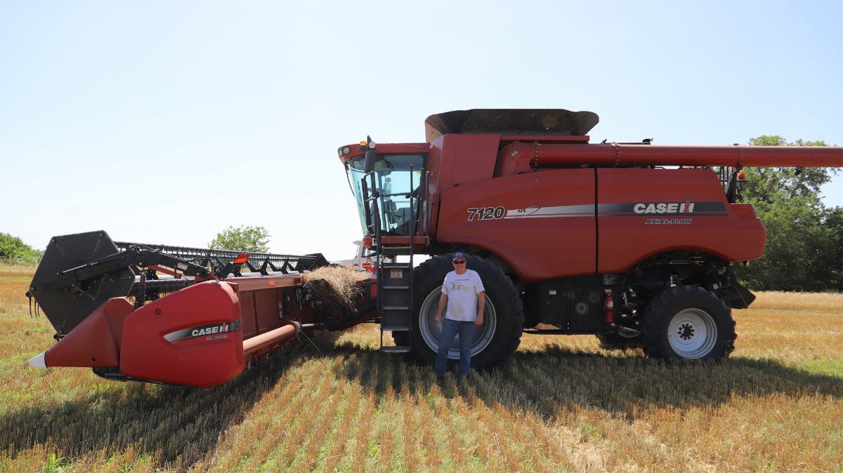 Randy Fritzemeier stands beside his combine during his final wheat harvest in 2022.