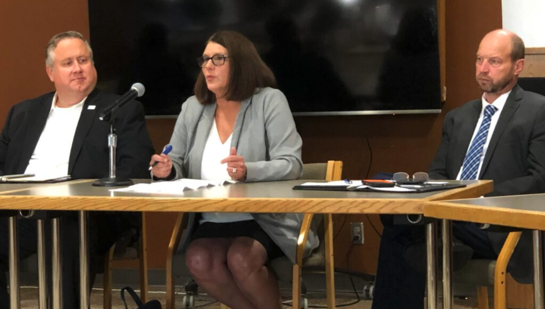 Kim Evans, Director of Family Support Division, speaks at a media event Aug. 26, alongside Robert Knodell, acting director of the Department of Social Services (left) and Patrick Luebbering, chief financial officer of the Department of Social Services (right).