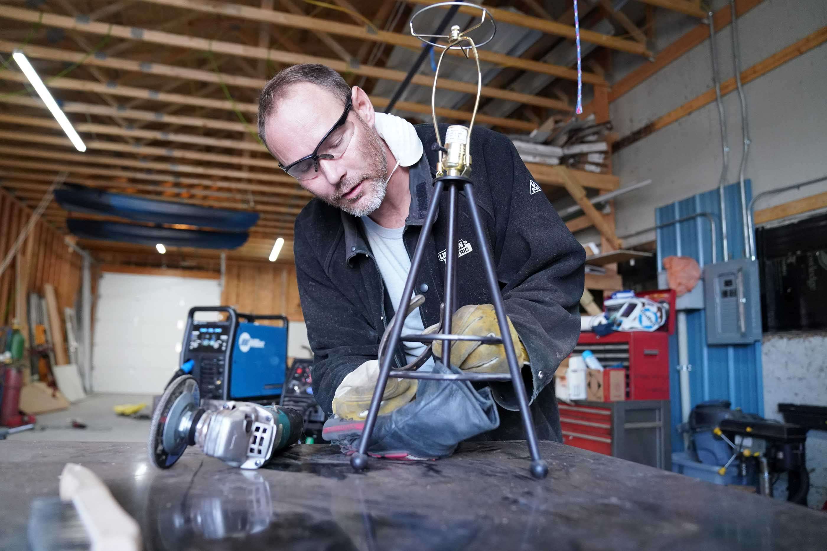 <i>Tim Ledford puts together a lamp for a customer Friday morning in Grant. Ledford is an alum of Mid-Plains Community College and the owner of Patriot Welding.</i>
