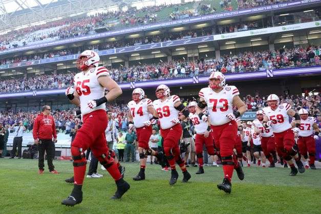 Nebraska players run onto the field before an NCAA college football game against Northwestern, Saturday, Aug. 27, 2022, at Aviva Stadium in Dublin, Ireland. (AP Photo/Peter Morrison)