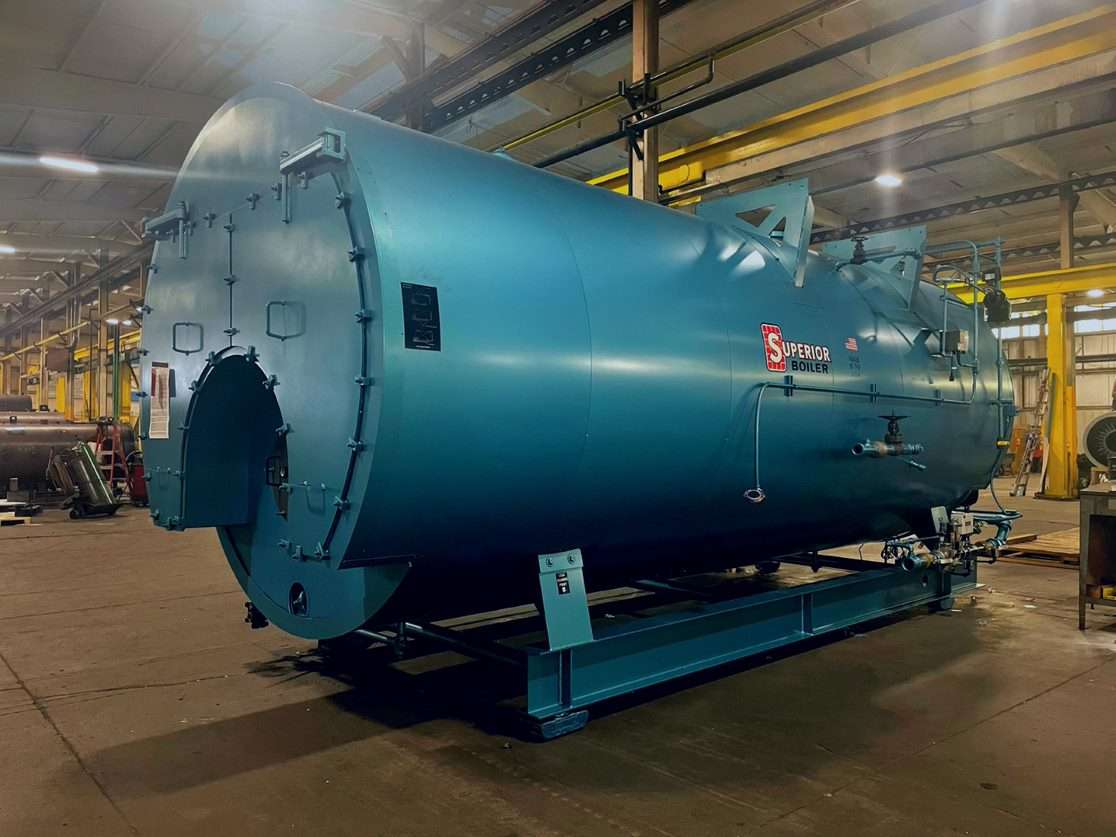 A firetube boiler is prepped for shipping in the final assembly area.