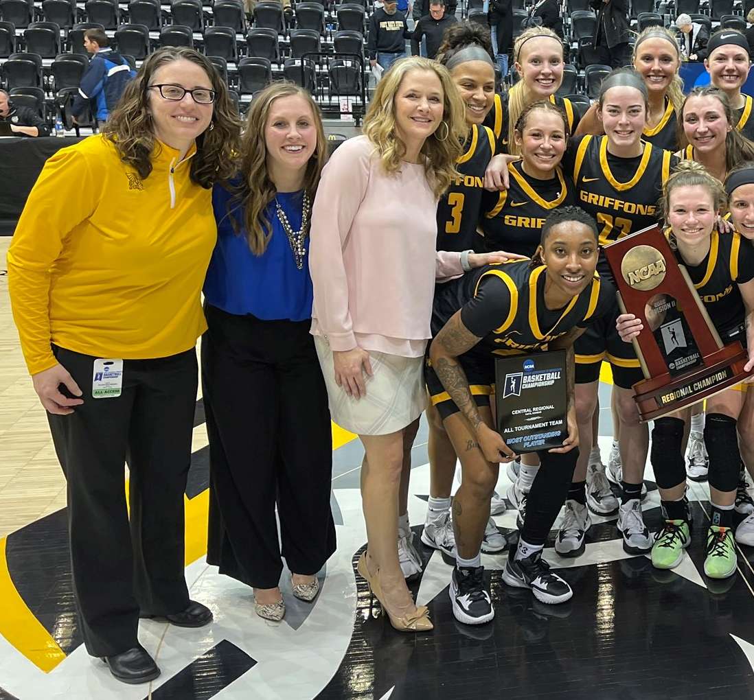 Missouri Western women's basketball coach Candi Whitaker (center, pink) is the winner of the inaugural St. Joseph Sports Commission Woman of Impact award. Her and the team, along with then interim athletic director Theresa Grosbach, pose after the Griffons' Central Region championship at Fort Hays State.