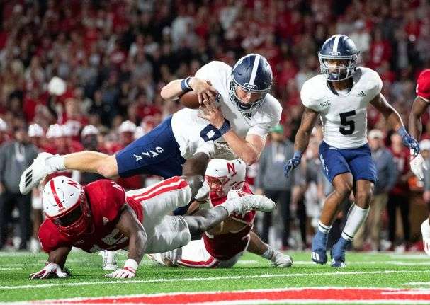 Georgia Southern quarterback Kyle Vantrease (6) leaps over Nebraska's Ernest Hausmann (15) to score a touchdown during the second half of an NCAA college football game Saturday, Sept. 10, 2022, in Lincoln, Neb. Georgia Southern won 45-42. (AP Photo/Rebecca S. Gratz)
