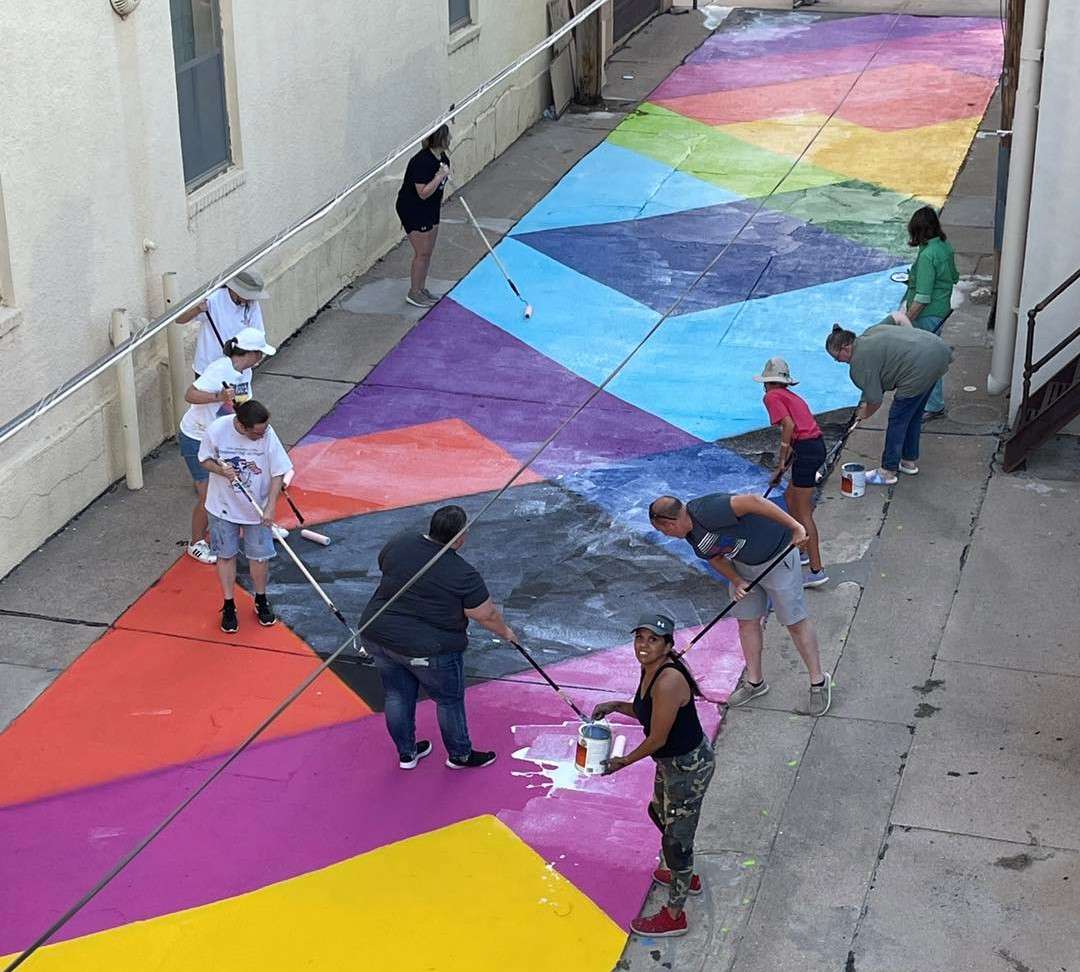 Melanie Ryan and volunteers put down color Friday afternoon.