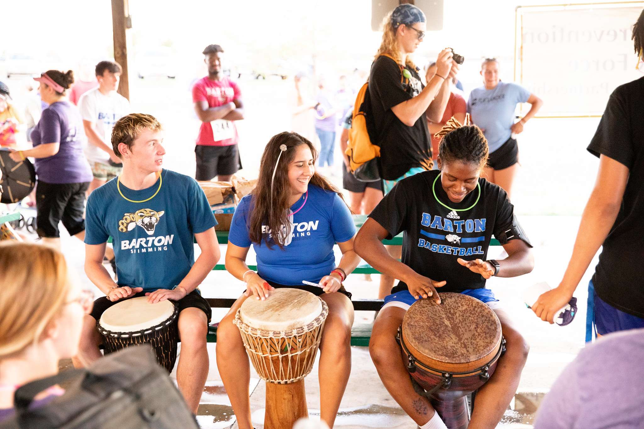Barton students practice playing the drums. John Makings from Rhythm Makings led a drum circle with participants during the Remembrance Ceremony before the race.