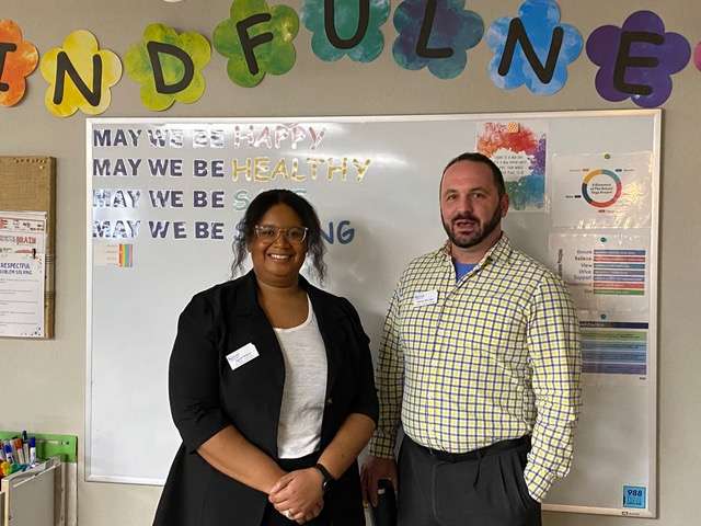 April White and Shaun Dierker talk with employees recently at The Center for Counseling and Consultation. They explained the basics of a Certified Community Behavioral Health Clinic on behalf of the Kansas Department for Aging and Disability Services.
