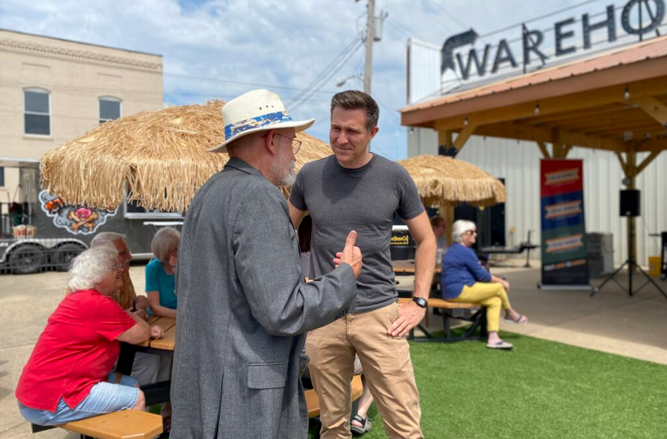 Lucas Kunce talks to Jim Martin, chair of the Perry County Democratic committee, before giving a campaign speech in Perryville in July 2022 (Allison Kite/Missouri Independent).